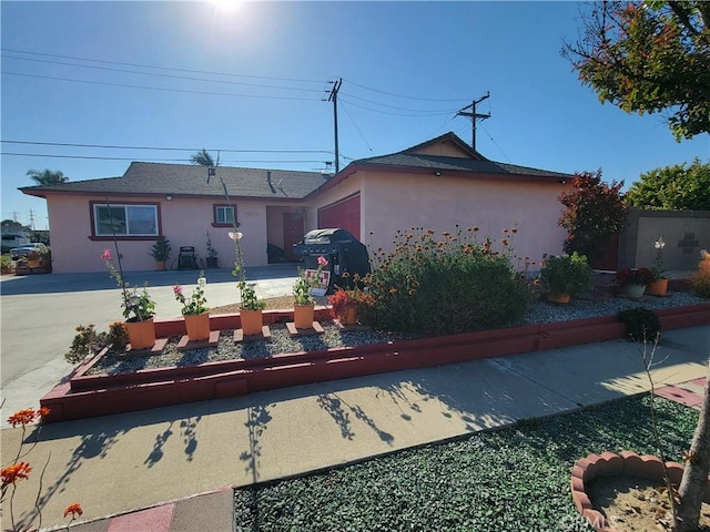7571 San Rafael Dr E, Buena Park, CA 90620 - view of front of property featuring stucco siding, driveway, and an attached garage