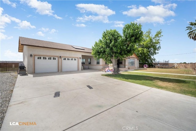 13271 Garzoli Ave, Mcfarland, CA 93250 - view of front of property with concrete driveway, a garage, solar panels, and stucco siding