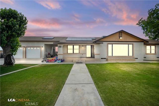 13271 Garzoli Ave, Mcfarland, CA 93250 - ranch-style house with an attached garage, solar panels, a front lawn, and roof with shingles