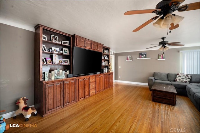 13271 Garzoli Ave, Mcfarland, CA 93250 - living room featuring light wood-style floors, ceiling fan, and baseboards