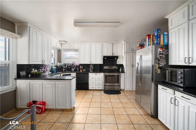 13271 Garzoli Ave, Mcfarland, CA 93250 - kitchen with stainless steel appliances, dark countertops, decorative backsplash, and plenty of natural light