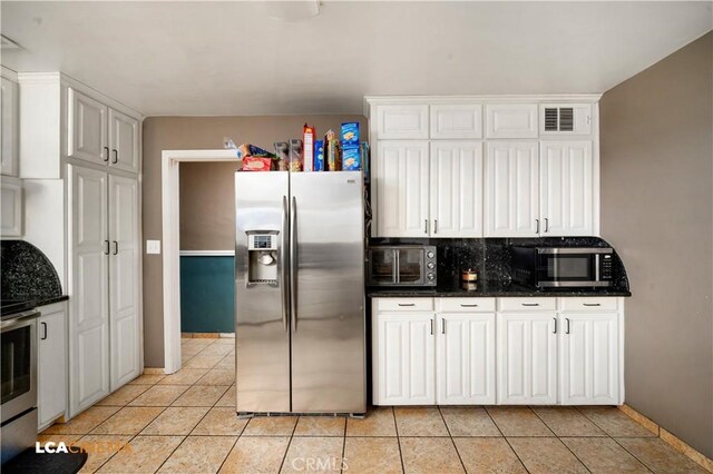 13271 Garzoli Ave, Mcfarland, CA 93250 - kitchen with stainless steel appliances, light tile patterned flooring, baseboards, and white cabinets