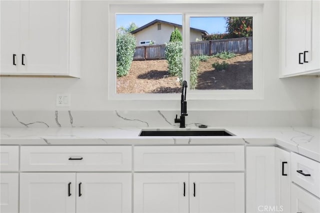 4708 Sunrise Rdg, Oceanside, CA 92056 - kitchen featuring a sink, white cabinets, and light stone counters