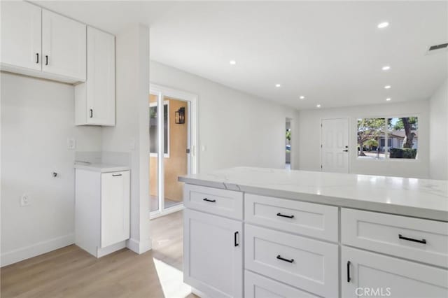 4708 Sunrise Rdg, Oceanside, CA 92056 - kitchen with light wood finished floors, light stone countertops, white cabinetry, baseboards, and recessed lighting