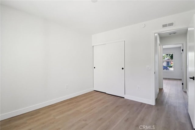 4708 Sunrise Rdg, Oceanside, CA 92056 - unfurnished bedroom featuring wood finished floors, baseboards, and a closet