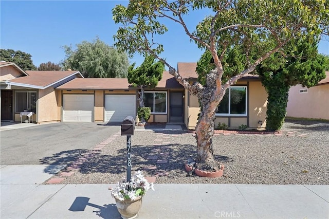 4708 Sunrise Rdg, Oceanside, CA 92056 - view of front facade with an attached garage, stucco siding, and asphalt driveway