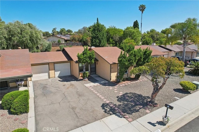 4708 Sunrise Rdg, Oceanside, CA 92056 - view of front of house featuring driveway, an attached garage, stucco siding, and a residential view