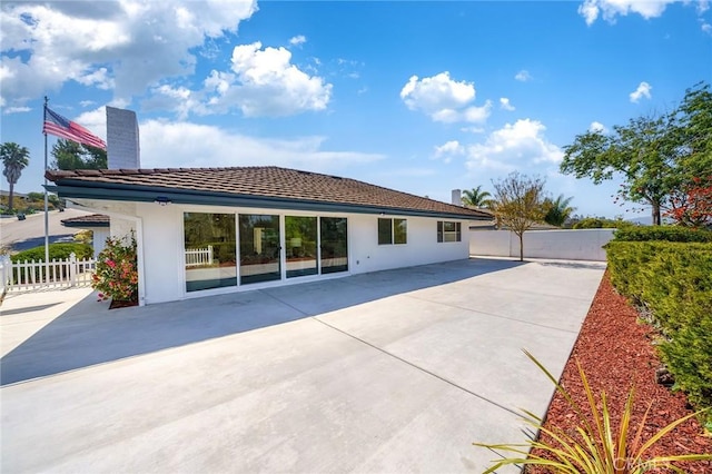 29461 Via Valverde, Laguna Niguel, CA 92677 - back of property with a patio, a chimney, a tiled roof, and stucco siding