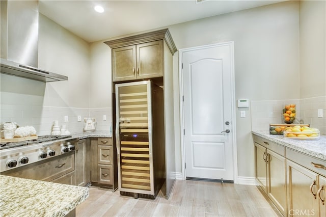46 Shadybend, Irvine, CA 92602 - kitchen featuring wall chimney range hood, wine cooler, stainless steel gas stovetop, light wood-style flooring, and tasteful backsplash