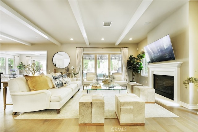 46 Shadybend, Irvine, CA 92602 - living area featuring beam ceiling, wood finished floors, a glass covered fireplace, baseboards, and recessed lighting