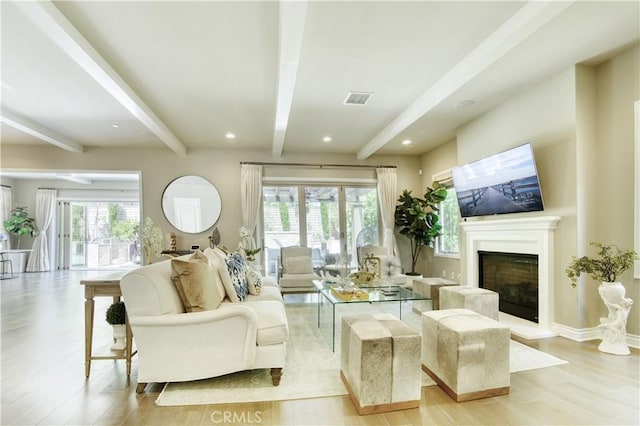 46 Shadybend, Irvine, CA 92602 - living area with beam ceiling, light wood finished floors, a glass covered fireplace, recessed lighting, and baseboards