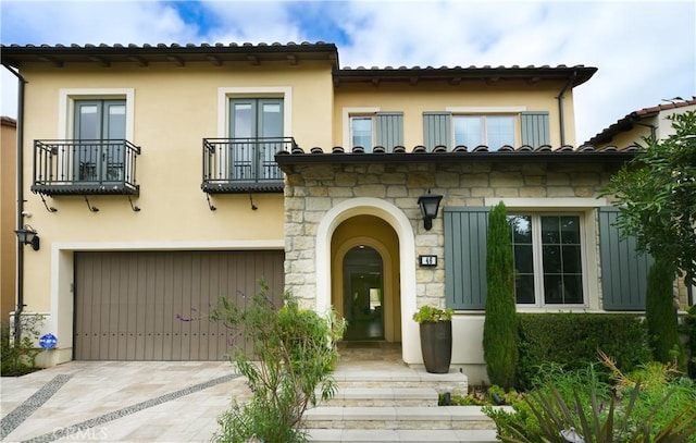 46 Shadybend, Irvine, CA 92602 - mediterranean / spanish home featuring a balcony, an attached garage, concrete driveway, and stucco siding