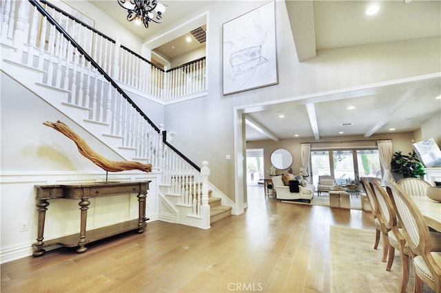 46 Shadybend, Irvine, CA 92602 - entryway with stairs, wood finished floors, a chandelier, and beam ceiling