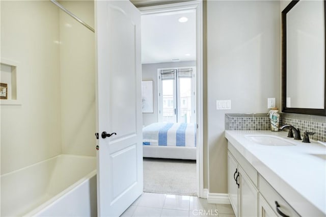 46 Shadybend, Irvine, CA 92602 - ensuite bathroom with vanity, tile patterned floors, baseboards, and tasteful backsplash