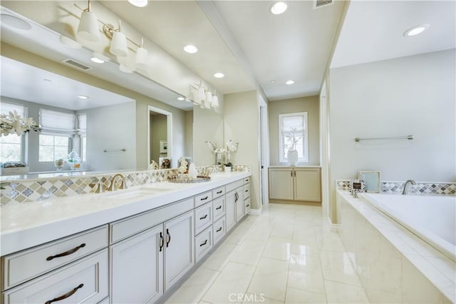 46 Shadybend, Irvine, CA 92602 - full bath featuring double vanity, a garden tub, baseboards, recessed lighting, and marble finish flooring