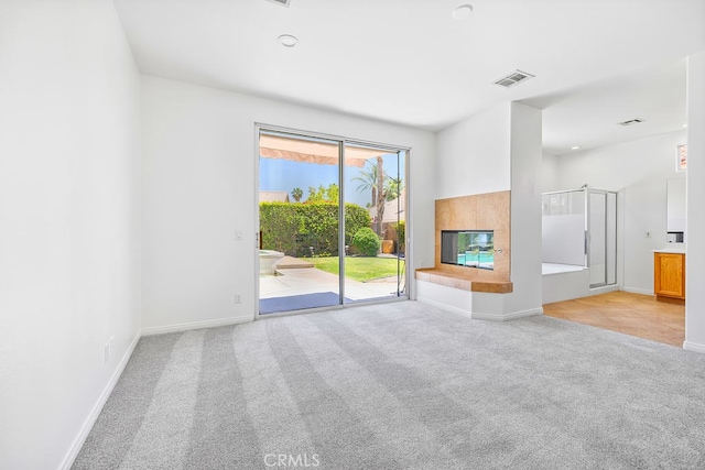 79030 Ladera Dr, La Quinta, CA 92253 - unfurnished living room featuring carpet flooring, baseboards, and a tile fireplace