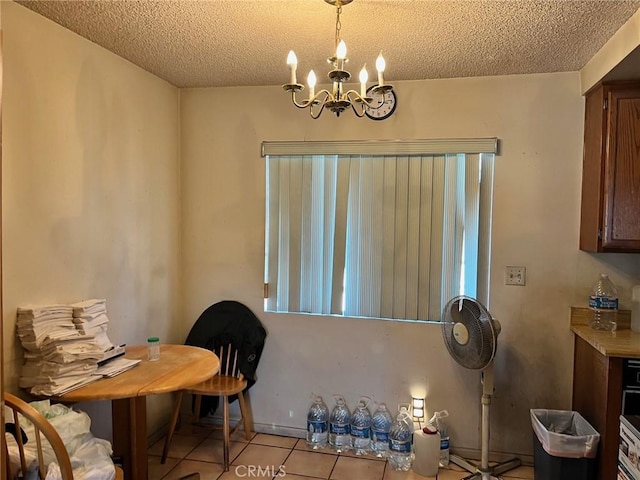 264 E Beverly Blvd Unit A, Montebello, CA 90640 - dining area with light tile patterned floors, a textured ceiling, and a chandelier