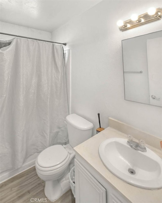3441 20th St, Highland, CA 92346 - bathroom featuring vanity, toilet, a shower with shower curtain, and wood finished floors