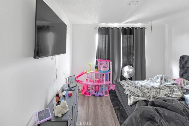 3441 20th St, Highland, CA 92346 - bedroom featuring a textured ceiling and wood finished floors