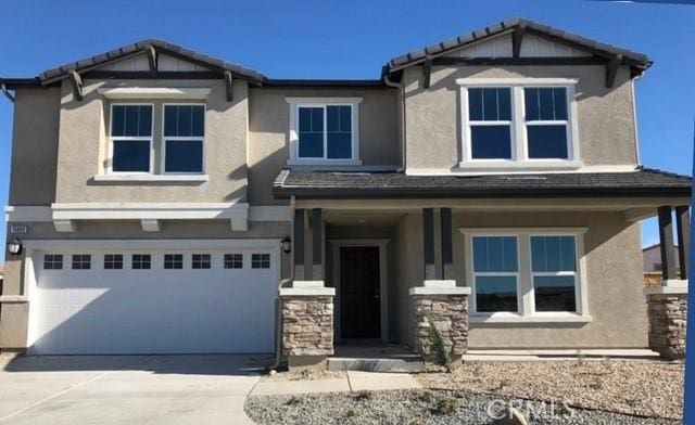 15893 Cordova Rd, Victorville, CA 92394 - craftsman-style home featuring stucco siding, an attached garage, and driveway
