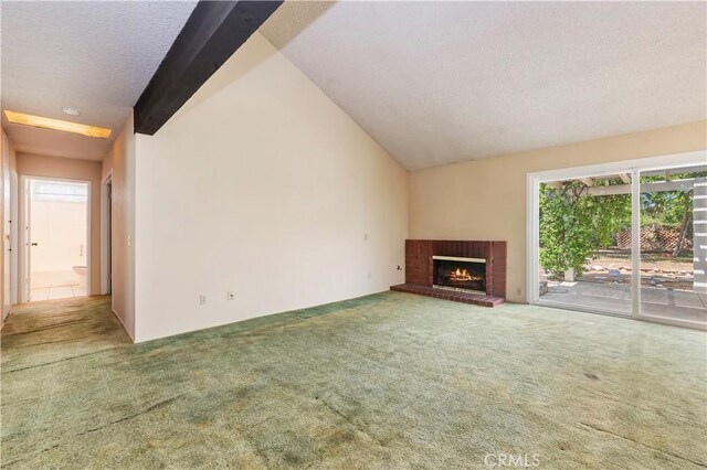 42769 Tierra Robles Pl, Temecula, CA 92592 - unfurnished living room with carpet, a textured ceiling, a fireplace, and vaulted ceiling
