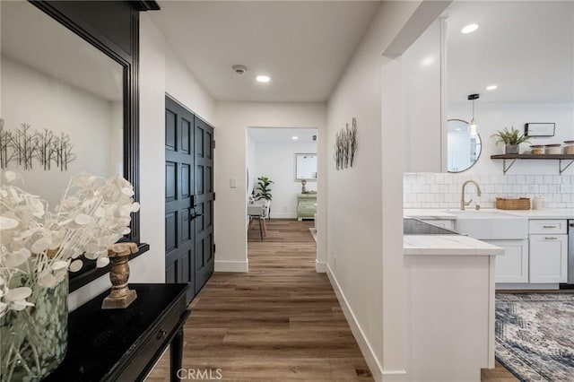 5700 Ravenspur Dr Unit 307, Rancho Palos Verdes, CA 90275 - hallway with wood finished floors, recessed lighting, baseboards, and a sink