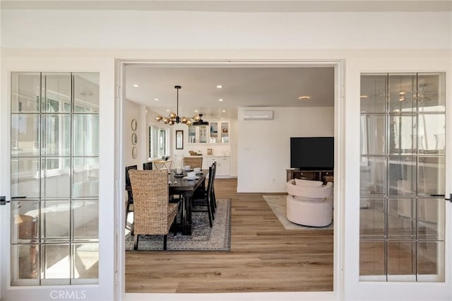 5700 Ravenspur Dr Unit 307, Rancho Palos Verdes, CA 90275 - dining space with light wood finished floors, a chandelier, a wall unit AC, and recessed lighting