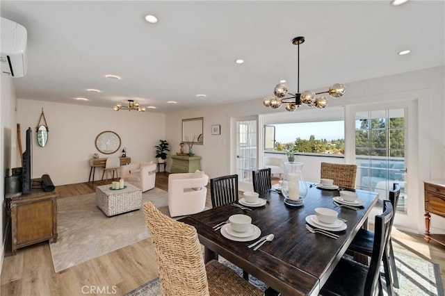 5700 Ravenspur Dr Unit 307, Rancho Palos Verdes, CA 90275 - dining area featuring a chandelier, a wall unit AC, light wood-style flooring, and recessed lighting