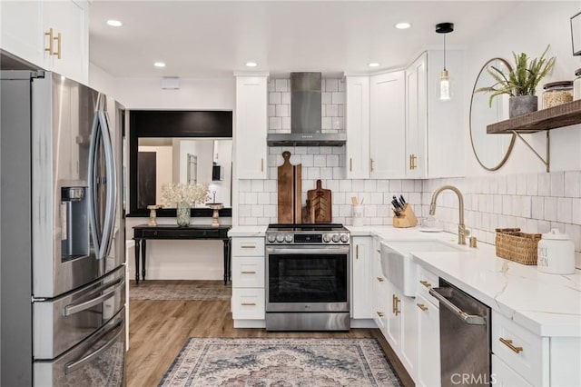 5700 Ravenspur Dr Unit 307, Rancho Palos Verdes, CA 90275 - kitchen featuring appliances with stainless steel finishes, wall chimney range hood, white cabinetry, a sink, and light wood-style floors