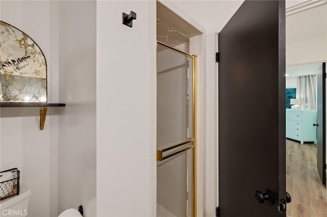 5700 Ravenspur Dr Unit 307, Rancho Palos Verdes, CA 90275 - full bathroom with toilet, a stall shower, and wood finished floors
