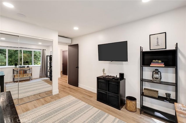 5700 Ravenspur Dr Unit 307, Rancho Palos Verdes, CA 90275 - living room featuring a wall unit AC, light wood finished floors, recessed lighting, and baseboards