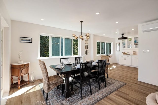 5700 Ravenspur Dr Unit 307, Rancho Palos Verdes, CA 90275 - dining space featuring light wood-type flooring, a wall mounted air conditioner, recessed lighting, a chandelier, and baseboards