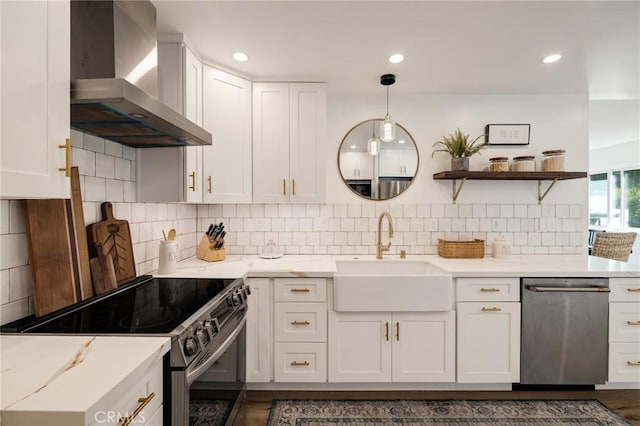 5700 Ravenspur Dr Unit 307, Rancho Palos Verdes, CA 90275 - kitchen with wall chimney range hood, appliances with stainless steel finishes, a sink, white cabinetry, and recessed lighting
