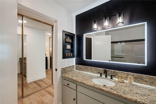 5700 Ravenspur Dr Unit 307, Rancho Palos Verdes, CA 90275 - bathroom featuring wood finished floors, vanity, and baseboards
