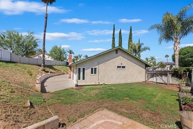 1326 Rosehill Dr, Riverside, CA 92507 - back of house with a patio area, a fenced backyard, and stucco siding