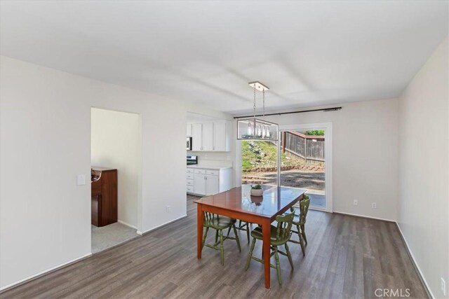 1326 Rosehill Dr, Riverside, CA 92507 - dining area with dark wood-type flooring and a chandelier