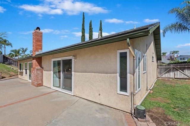1326 Rosehill Dr, Riverside, CA 92507 - rear view of house with a chimney, a patio, and stucco siding