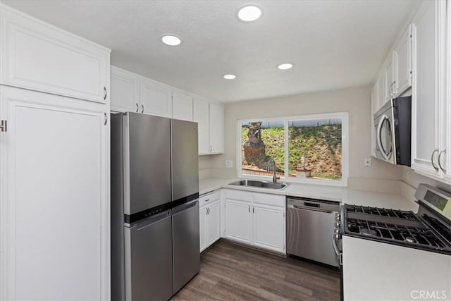 1326 Rosehill Dr, Riverside, CA 92507 - kitchen featuring appliances with stainless steel finishes, white cabinetry, dark wood-style flooring, and recessed lighting