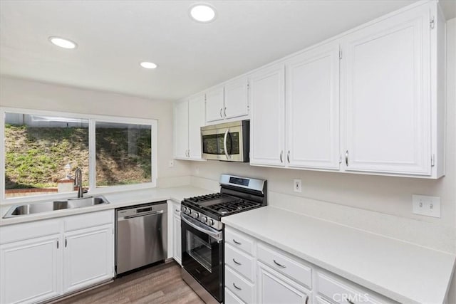 1326 Rosehill Dr, Riverside, CA 92507 - kitchen featuring stainless steel appliances, white cabinets, recessed lighting, light countertops, and light wood-type flooring