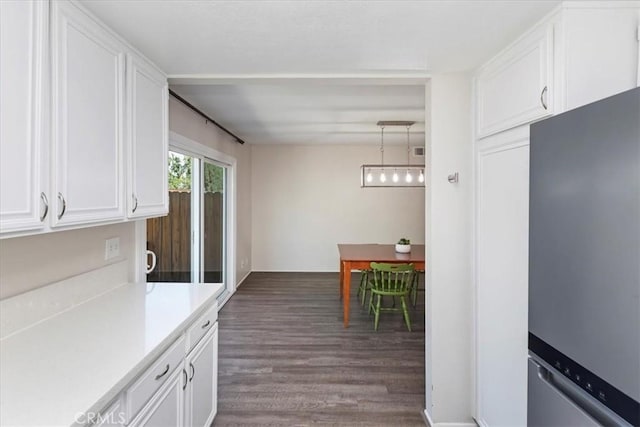 1326 Rosehill Dr, Riverside, CA 92507 - kitchen featuring freestanding refrigerator, light countertops, white cabinets, and dark wood-style flooring