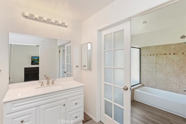 1326 Rosehill Dr, Riverside, CA 92507 - full bath with vanity, washtub / shower combination, and wood finished floors