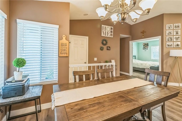 2618 W Loma Vista Dr, Rialto, CA 92377 - dining room with a chandelier, wood finished floors, healthy amount of natural light, baseboards, and lofted ceiling