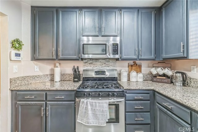 2618 W Loma Vista Dr, Rialto, CA 92377 - kitchen featuring appliances with stainless steel finishes and light stone countertops