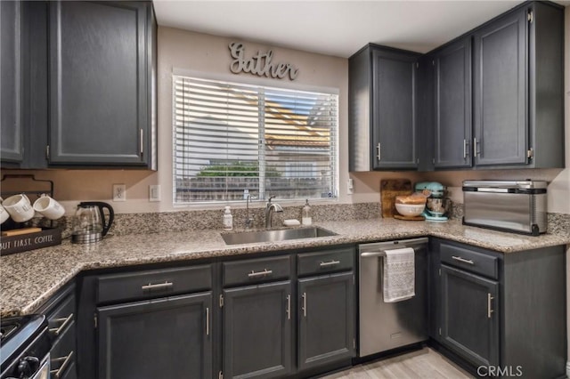 2618 W Loma Vista Dr, Rialto, CA 92377 - kitchen with stainless steel appliances, a sink, light countertops, and light wood-type flooring