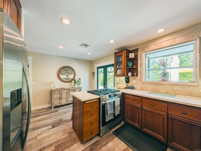 8635 La Butte Ln, Santee, CA 92071 - kitchen featuring stainless steel appliances, a peninsula, light wood-style floors, light countertops, and recessed lighting