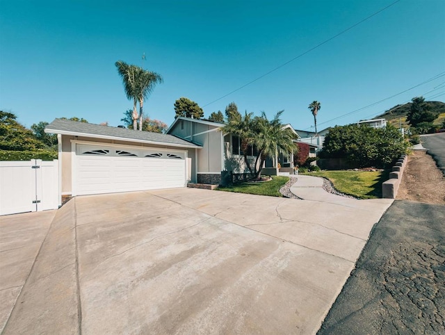 8635 La Butte Ln, Santee, CA 92071 - view of front of house with concrete driveway, stone siding, a gate, and stucco siding