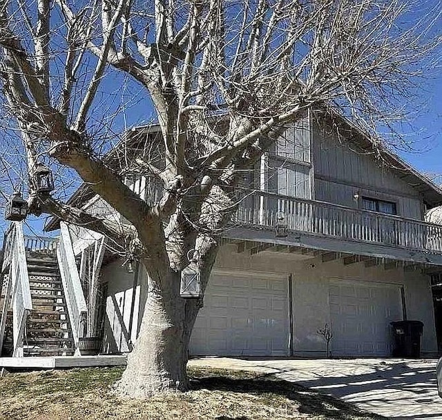 43323 Lookabout Rd, Lake Hughes, CA 93532 - view of home's exterior featuring a garage, stairway, and a balcony