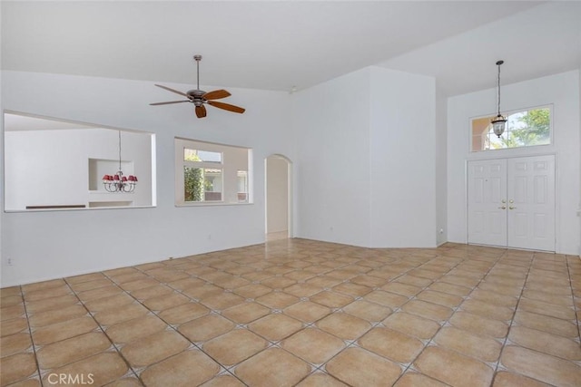 24563 Calle Perla, Murrieta, CA 92562 - unfurnished living room featuring ceiling fan, arched walkways, and lofted ceiling