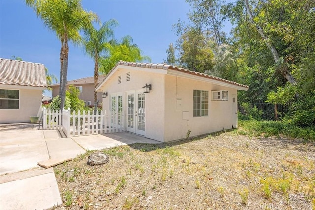 24563 Calle Perla, Murrieta, CA 92562 - view of home's exterior with french doors, a patio, stucco siding, and a tile roof