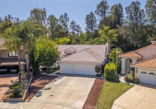 24563 Calle Perla, Murrieta, CA 92562 - mediterranean / spanish home with a tiled roof, driveway, stucco siding, and a garage
